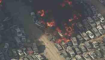 Several hundred crushed cars burn in a massive junkyard fire near L.A.