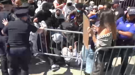 Masked anti-Israel protesters at Columbia University demonstrate as students check in for first day of classes