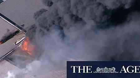 Smoke billows across Sydney's south-west as huge industrial fire burns