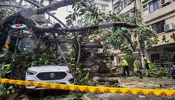 Flooded streets and wild waves as typhoon hits Taiwan