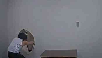 Murder suspect escapes by kicking hole through interrogation room wall