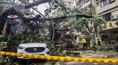 Flooded streets and wild waves as typhoon hits Taiwan