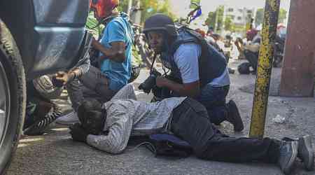 Haiti swears in a new prime minister as gangs open fire at a flight landing in the main airport