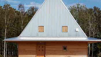 This Little Wooden Cabin On The Swedish Coast Boasts An Unusual Hat-Shaped Metal Roof