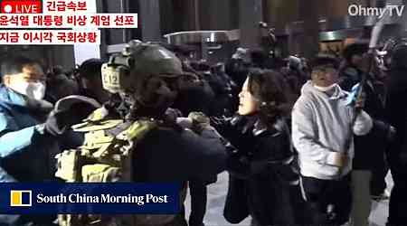 South Korean politician hailed after clash with armed soldier during martial law protests