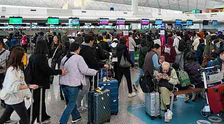 Crowds throng at busy Hong Kong airport as residents depart for holidays