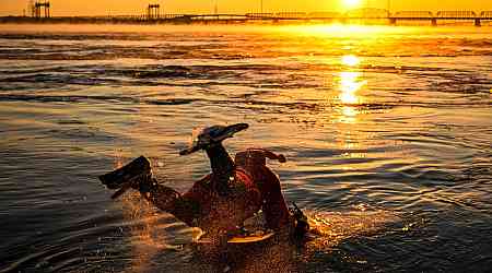 Ho! Ho! HOLY that's cold! Montreal boogie boarder in Santa suit hits St. Lawrence waters