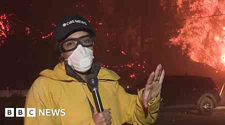 Watch: Ferocious and explosive fire burns behind CBS reporter