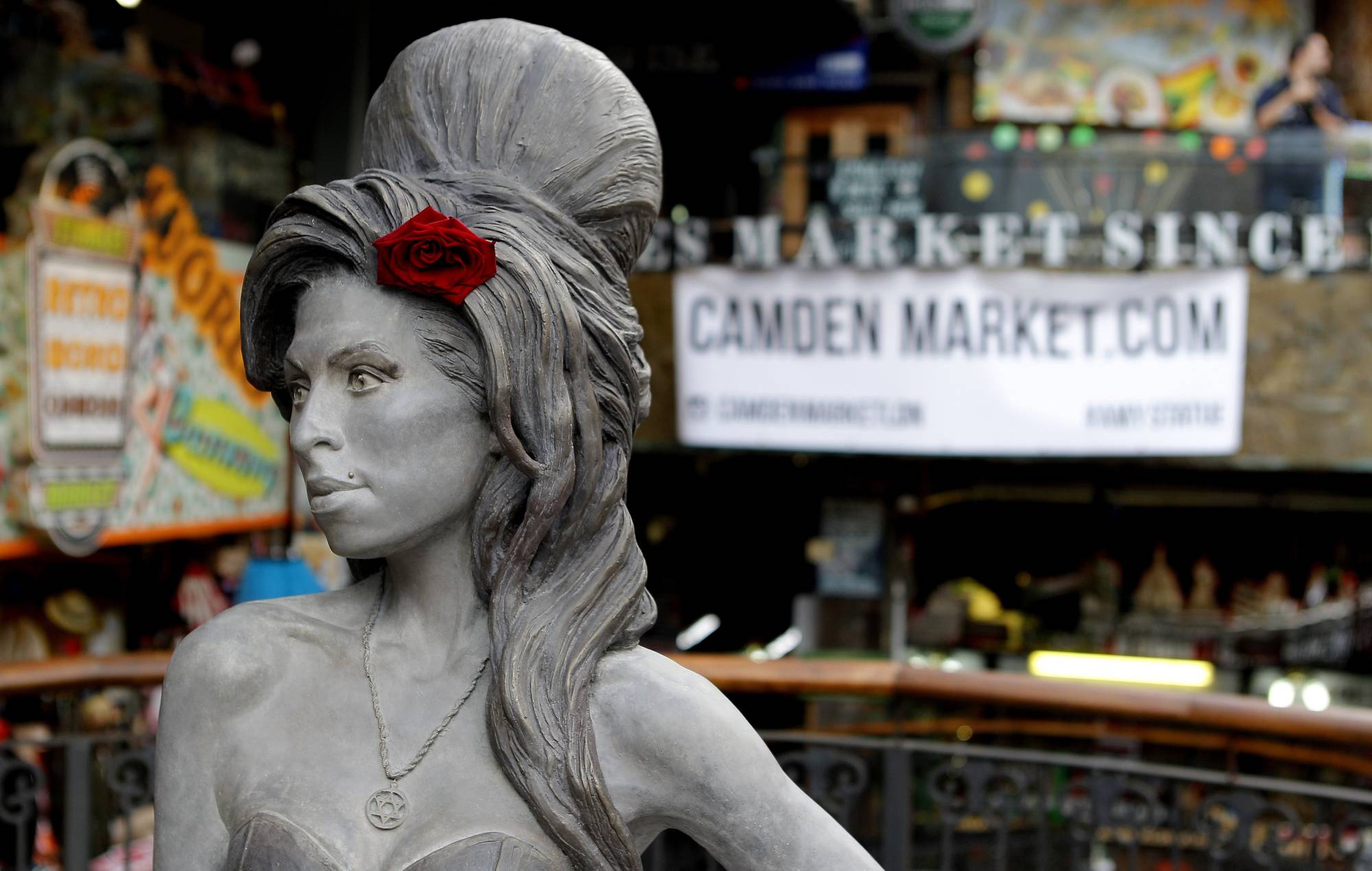 Star of David necklace on Amy Winehouse statue in Camden covered by Palestine sticker