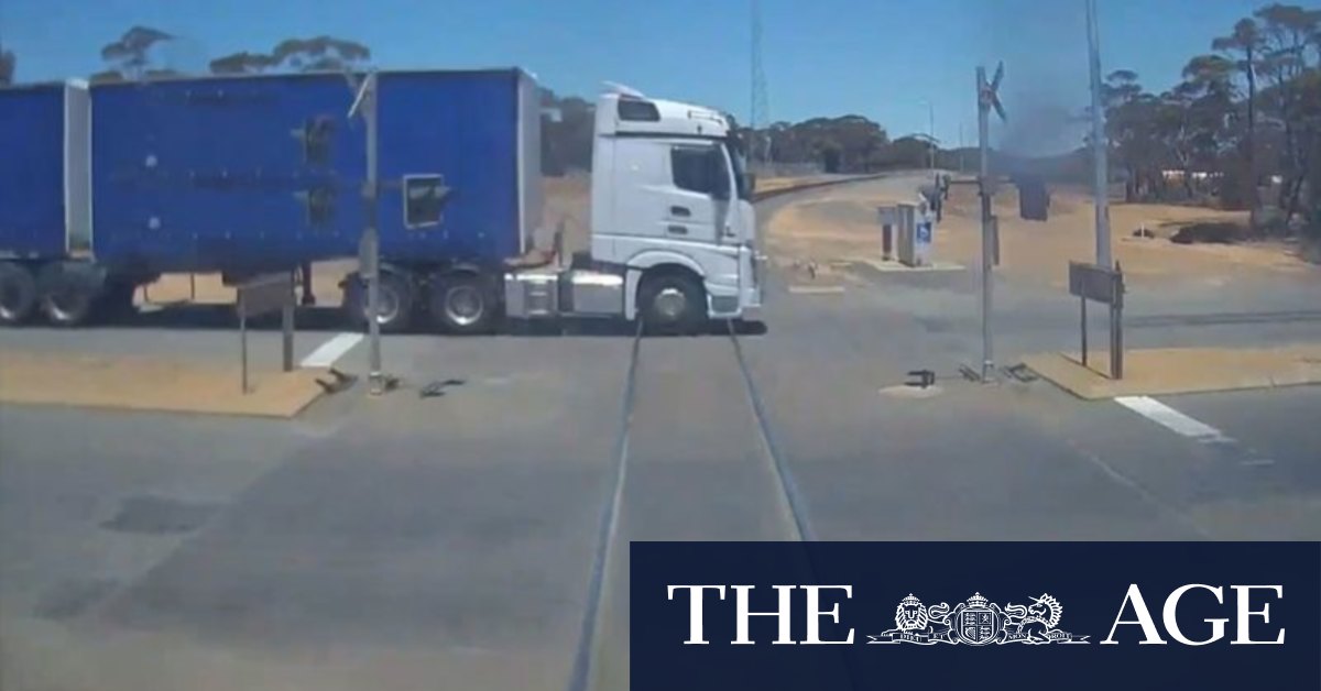 Watch the heart-stopping moment a freight train barely misses truck