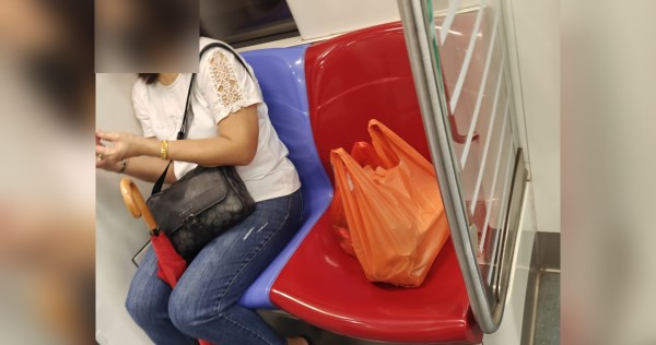 'Go find other places to sit': Woman hogs MRT train priority seat with bags, 'swipes' away passenger with joint issues