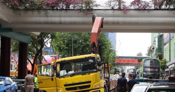 Lorry driver arrested after crane hits Chinatown overhead bridge