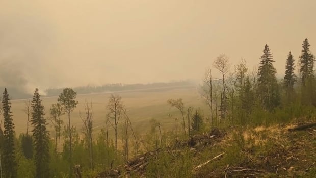 As crews battle fire near Fort Nelson, B.C., a bigger blaze is moving closer