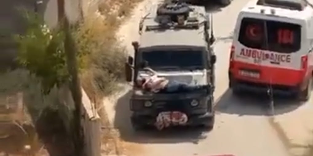 Video shows wounded Palestinian man strapped to Israeli military jeep as IDF says soldiers violated protocol