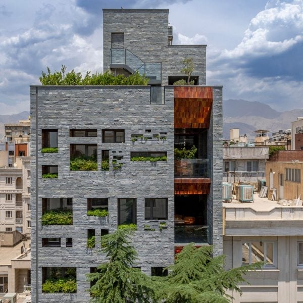 Glazed copper-coloured bricks reflect light into Tehran apartment block by Hooba Design Group