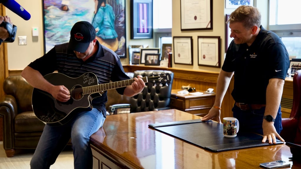 N.L. premier gifts new guitar christened by music icon to one of the 'Lucky Seven'