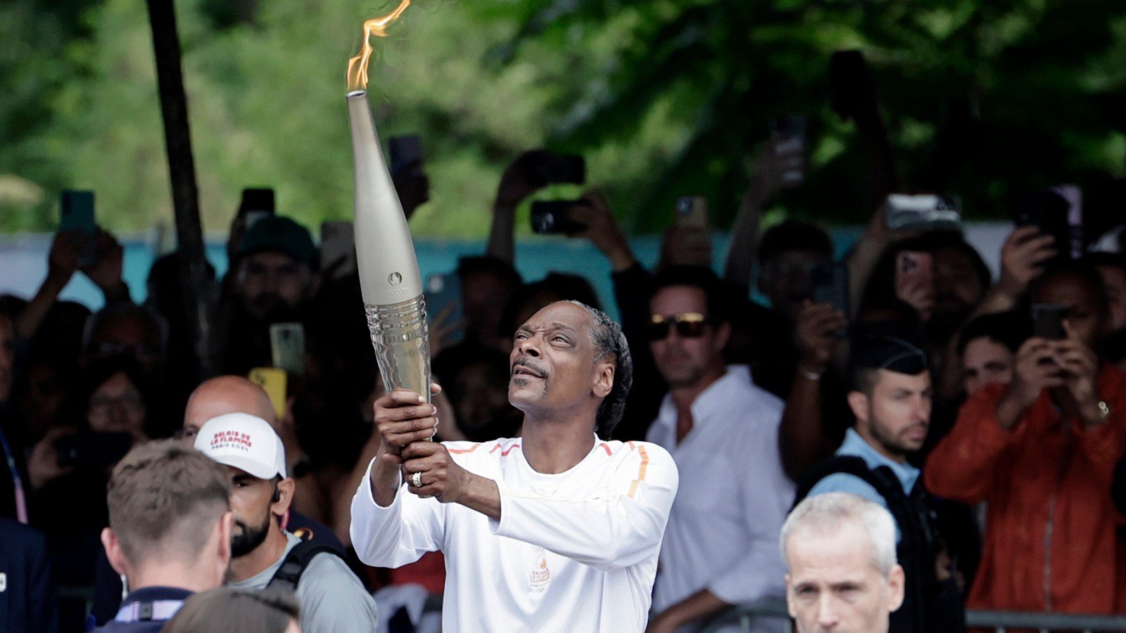 See Snoop Dogg Serve as Torch Bearer Ahead of Paris Olympics