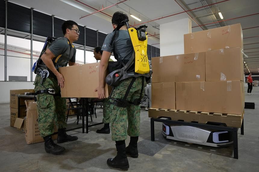 Soldiers don exoskeleton suits, operate automated packing line to prepare 2024 NDP packs