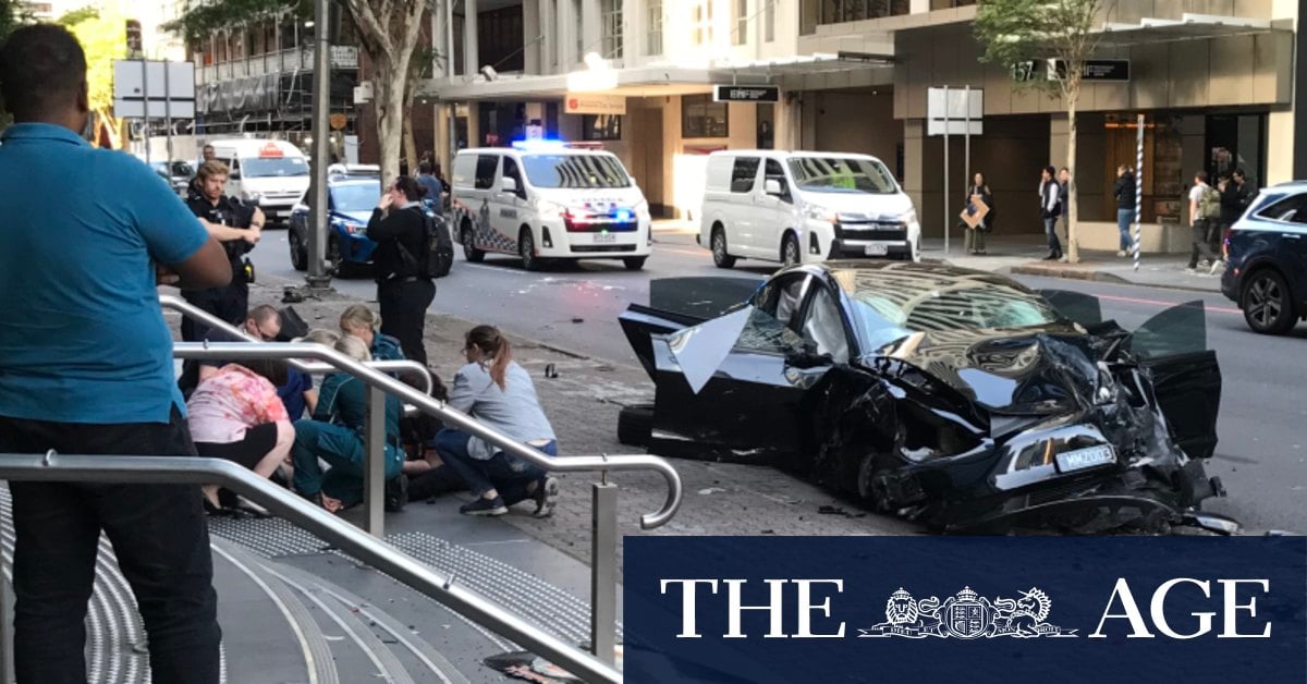 Three hospitalised after Tesla and ambulance crash in Brisbane CBD