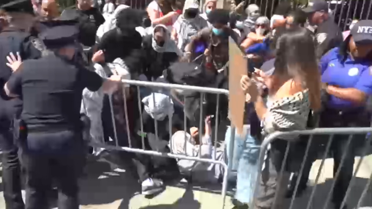 Masked anti-Israel protesters at Columbia University demonstrate as students check in for first day of classes