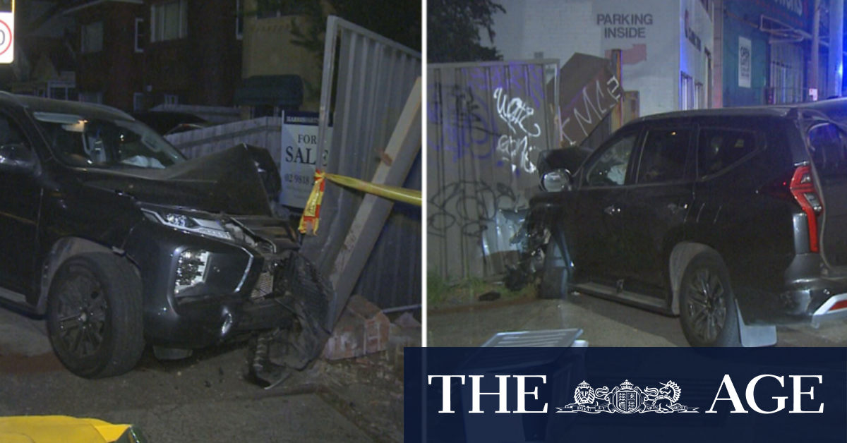 Car smashes through Sydney fence