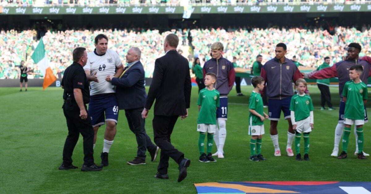 England players baffled as pitch invader lines up for national anthem in full kit