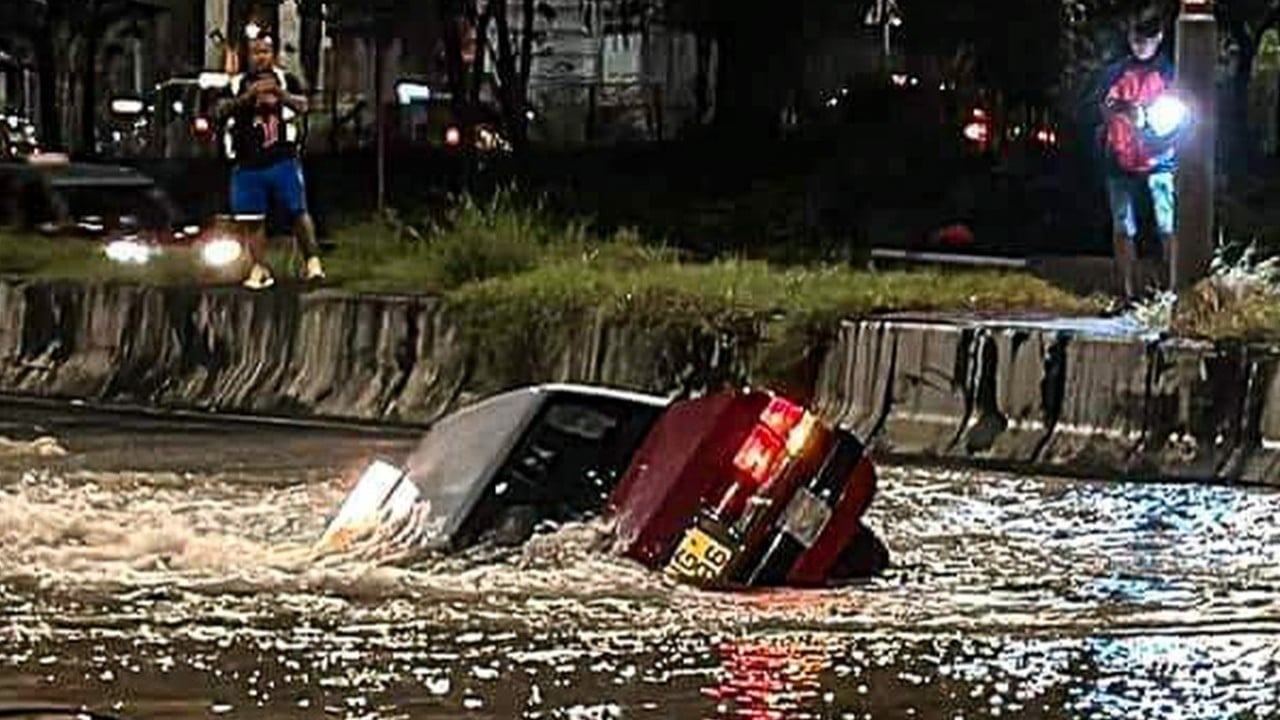 Hong Kong taxi driver injured, passenger unscathed as cab plunges into flooded sinkhole