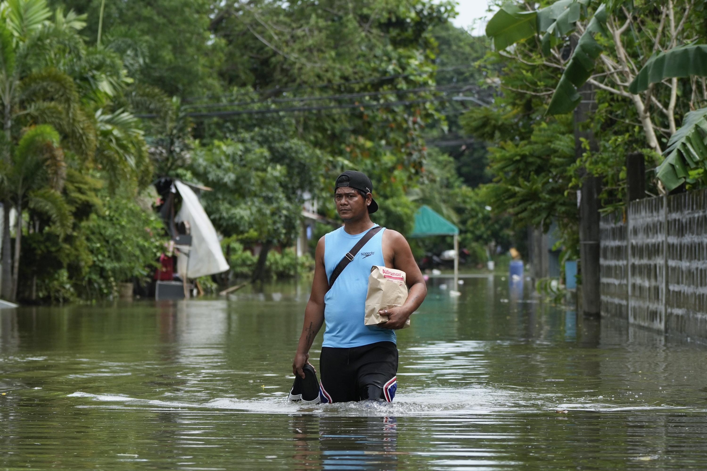 Storm blows away from northern Philippines leaving 65 dead but forecasters warn it may do a U-turn