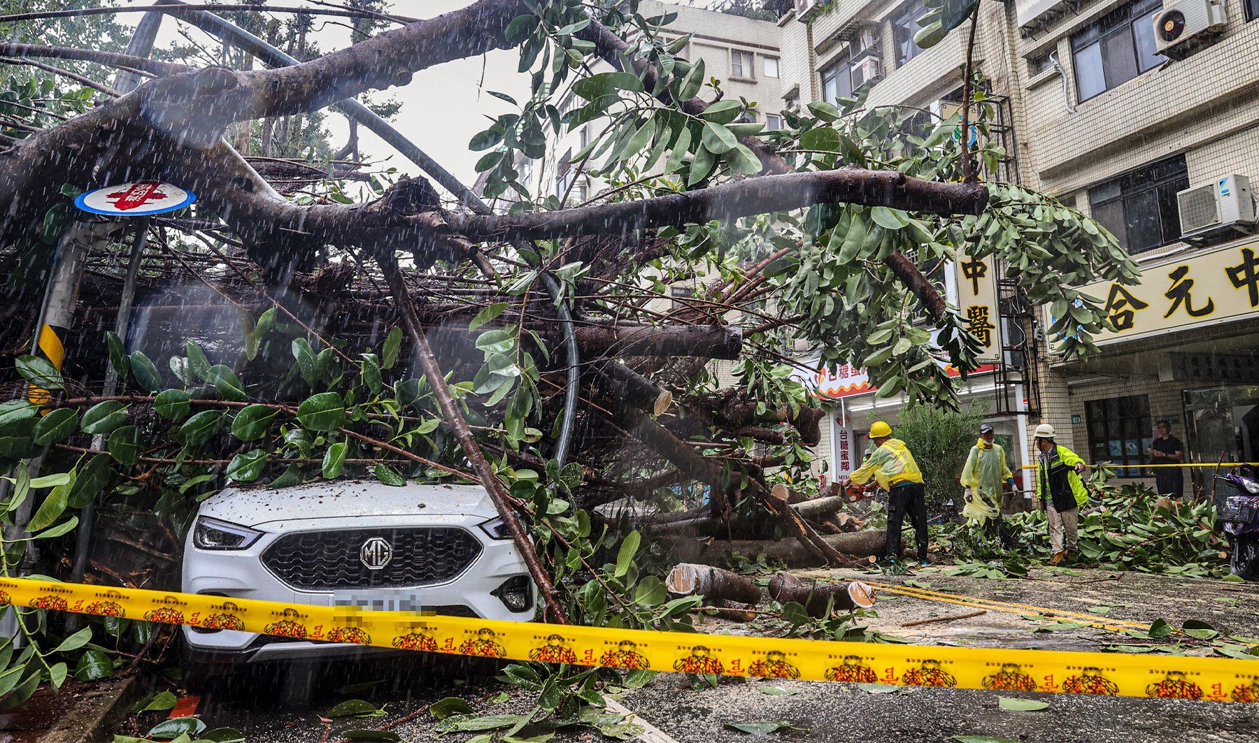 Flooded streets and wild waves as typhoon hits Taiwan