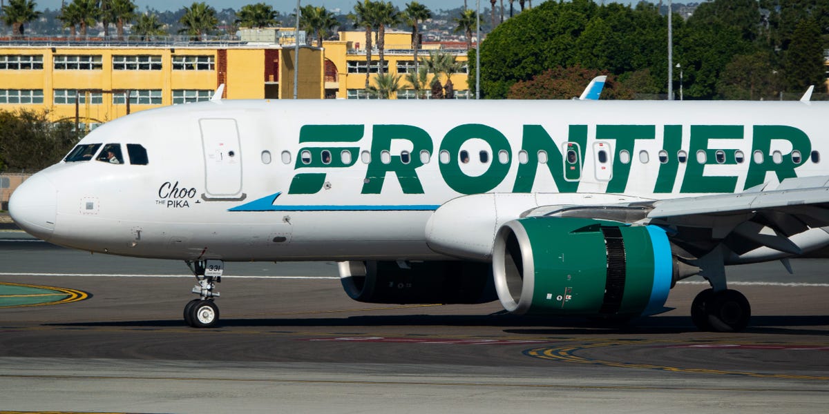 A group of Frontier Airlines passengers are suing, saying they were kept on a 'smoke-filled' plane for nearly an hour