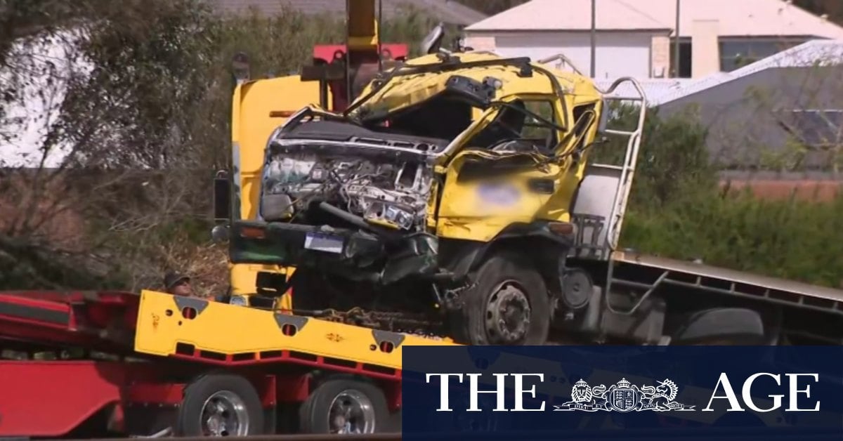 Driver dies after truck rolls and crashes through a barrier