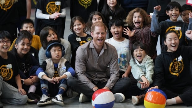 Prince Harry plays volleyball with Vancouver schoolchildren after appearance at Grey Cup