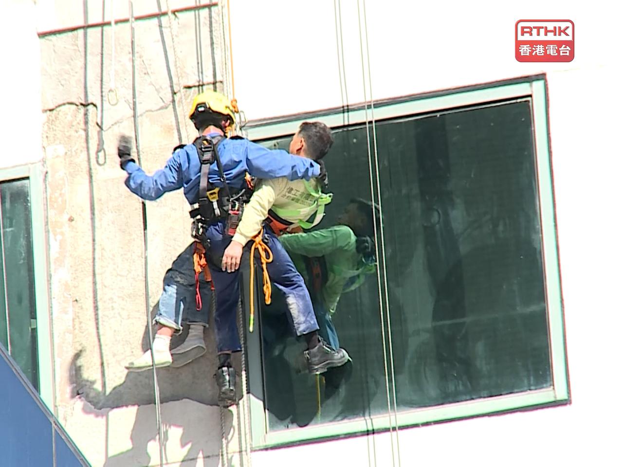 Worker rescued after being suspended from building