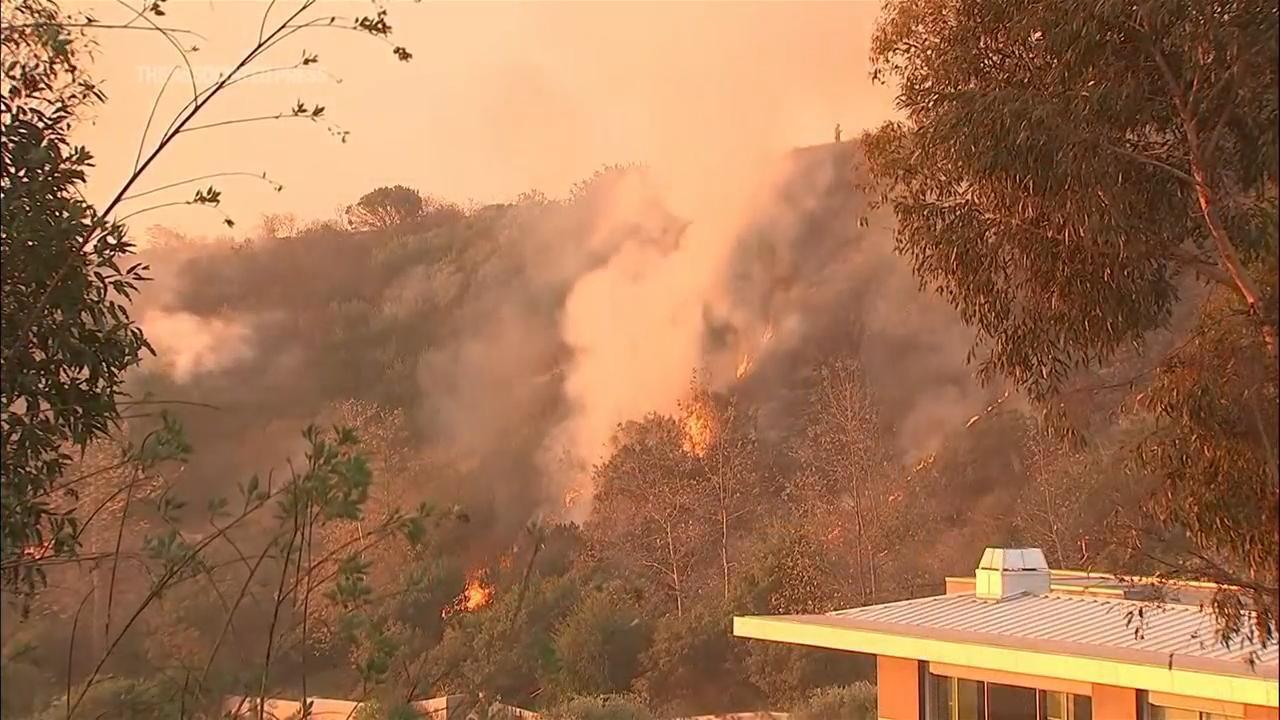 Homes burn as wind-driven wildfire prompts evacuations in Malibu, California