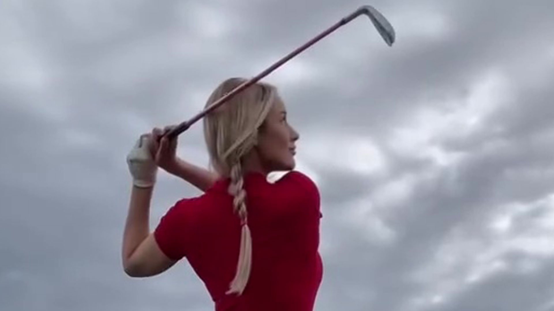 Paige Spiranac goes braless and risks wardrobe malfunction as she shows off golf swing in tight red playsuit