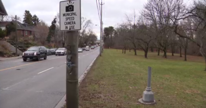 Toronto speed camera chopped down again and thrown into pond