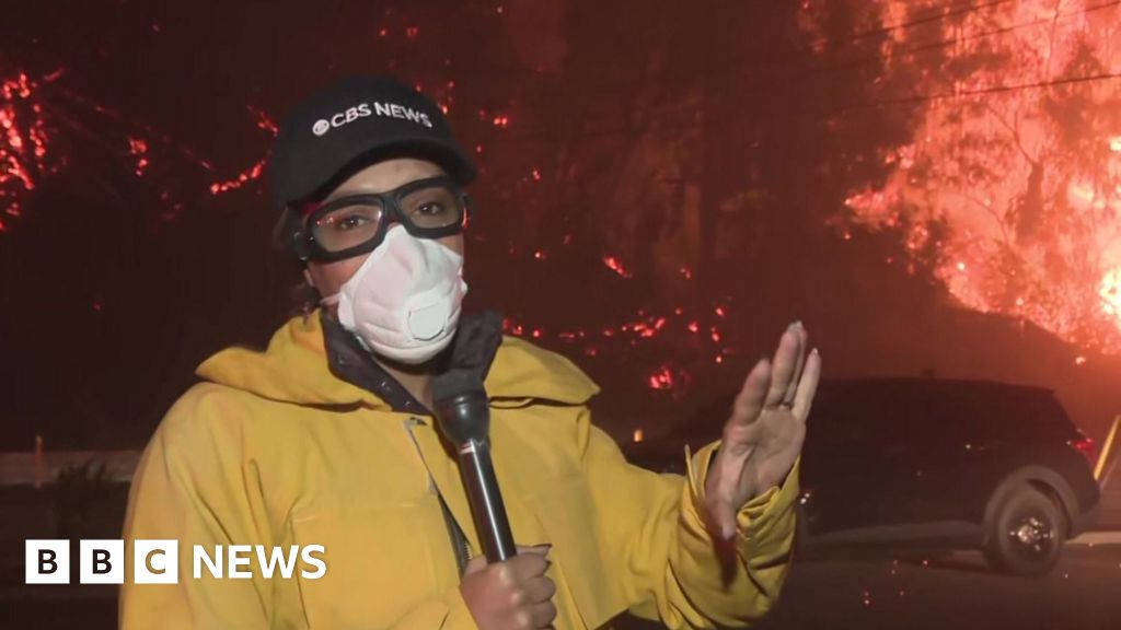 Watch: Ferocious and explosive fire burns behind CBS reporter