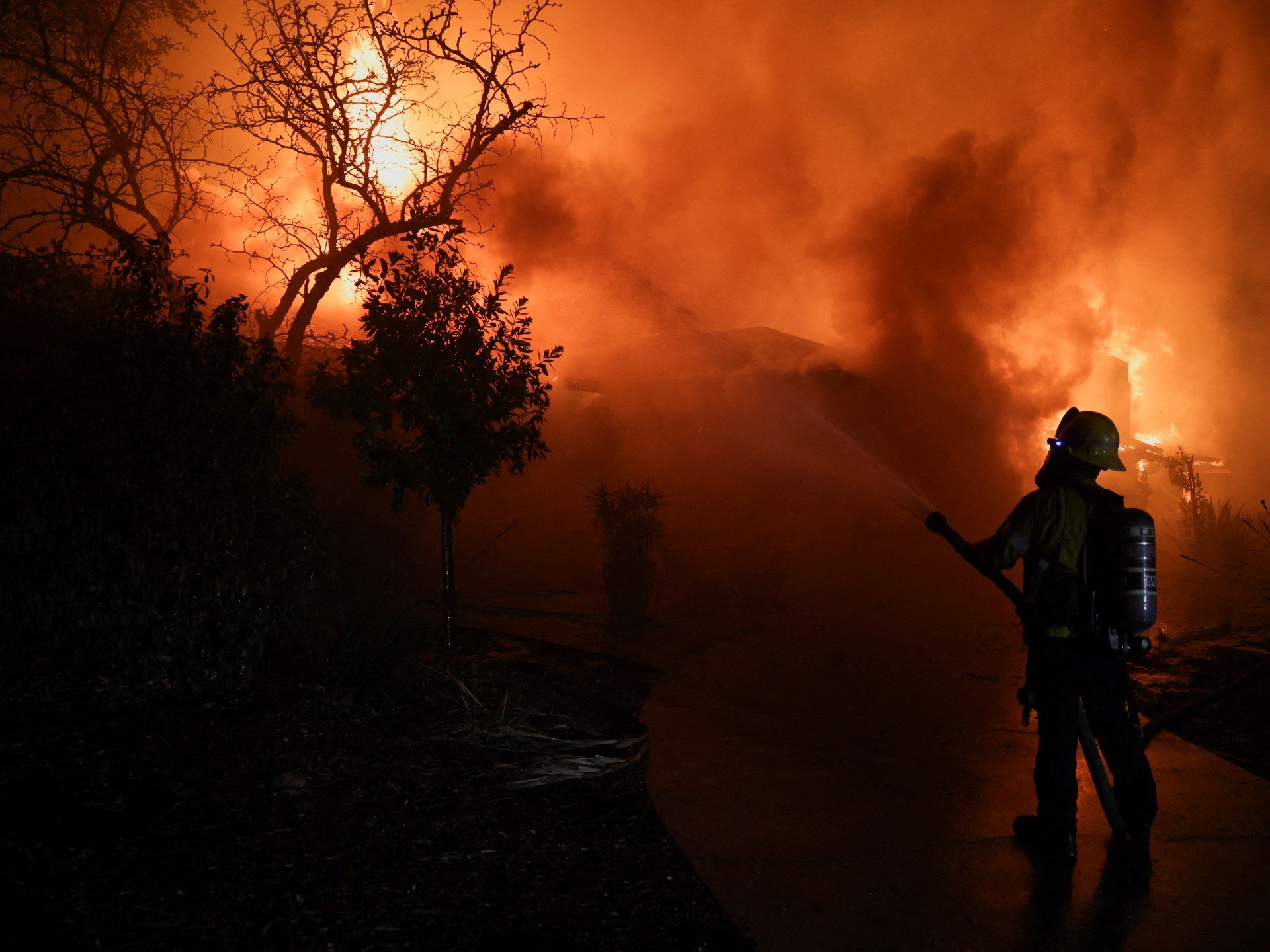 Los Angeles wildfires live news: Tens of thousands flee homes in California